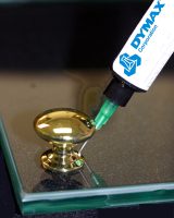 Bonding gold doorknob to glass door with Dymax UV Glass Bonding adhesive