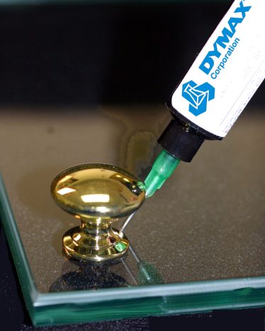 Bonding gold doorknob to glass door with Dymax UV Glass Bonding adhesive