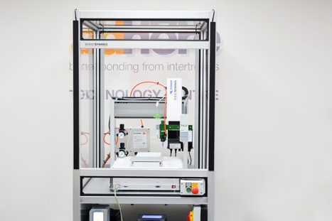 Automated dispensing and UV light curing system