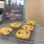 "You're welcome here" sign with freshly baked cookies