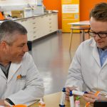 Ben and Darren looking at adhesive