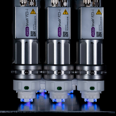 Multiple PZ3-i piezobursh plasma treatment systems suspended over a part