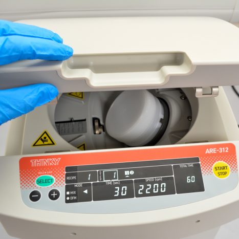 Loading a mixing cup into an ARE-312 mixing machine